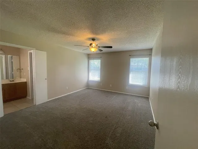 a view of a livingroom and a chandelier fan