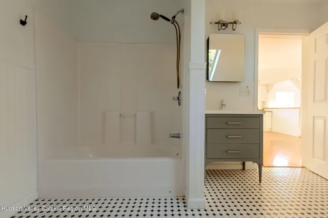a bathroom with a bathtub and a shower