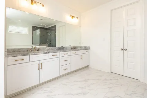 a bathroom with a granite countertop sink mirror and