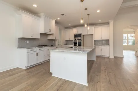 a kitchen with a white wooden cabinets and white appliances