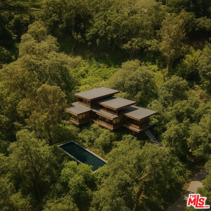an aerial view of residential house with outdoor space and trees all around