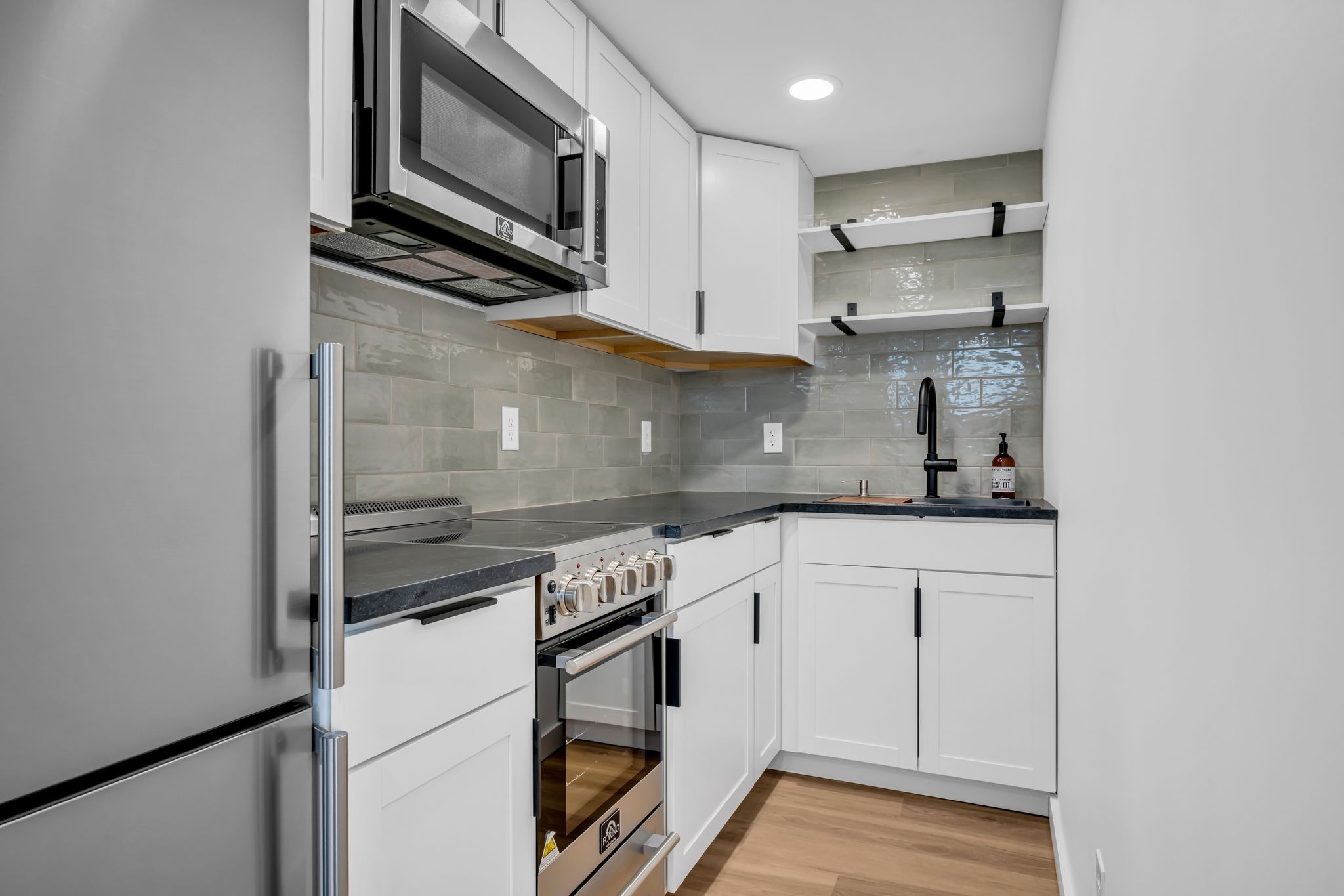 1033 Pine Valley Road Kingston Springs, TN 37082 - Photo 28 of 42 a kitchen with stainless steel appliances white cabinets and a stove top oven