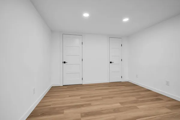 a view of hallway with livingroom and wooden floor