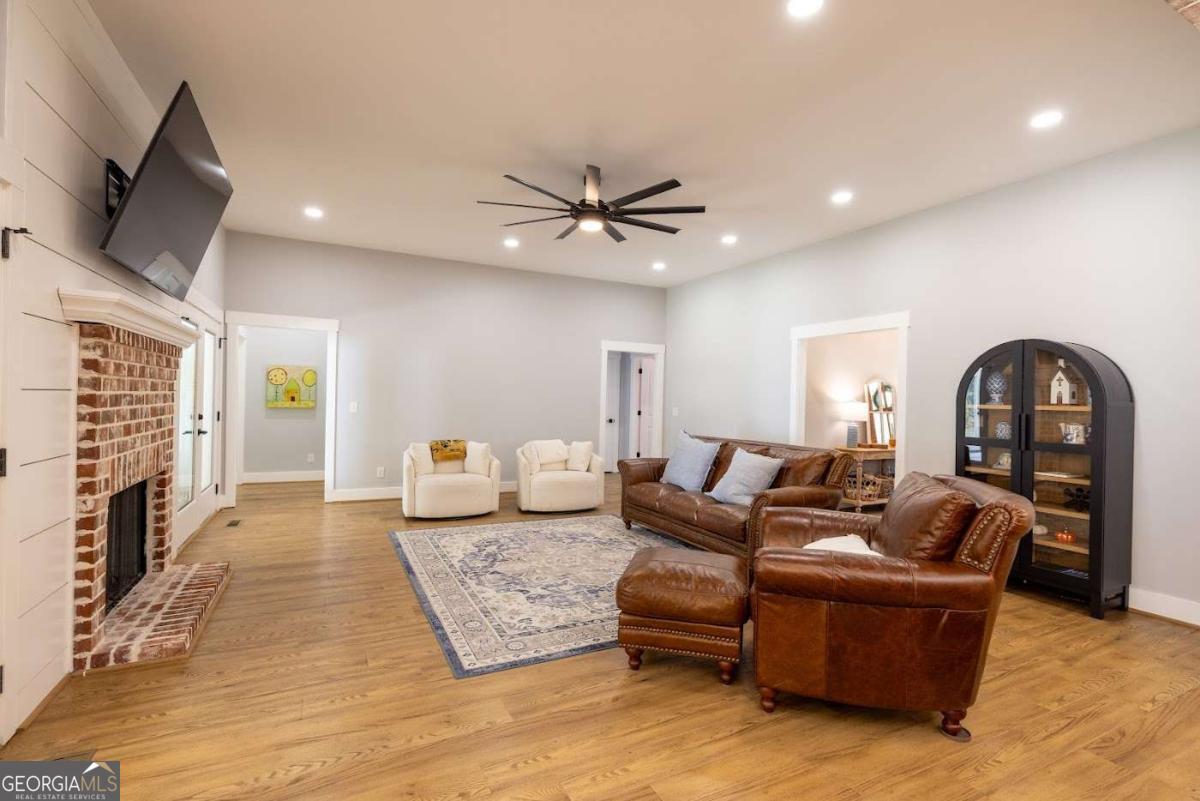 988 Boozer Road Heflin, AL 36264 - Photo 11 of 52 a living room with furniture and a flat screen tv