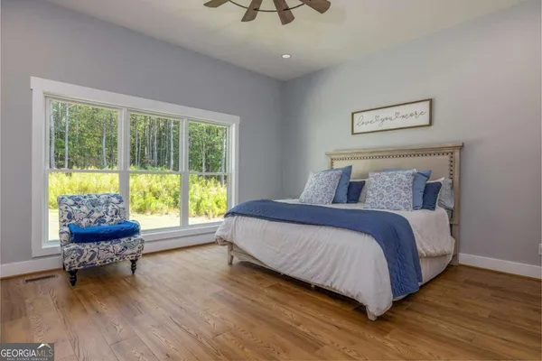 a bedroom with a bed and a chair