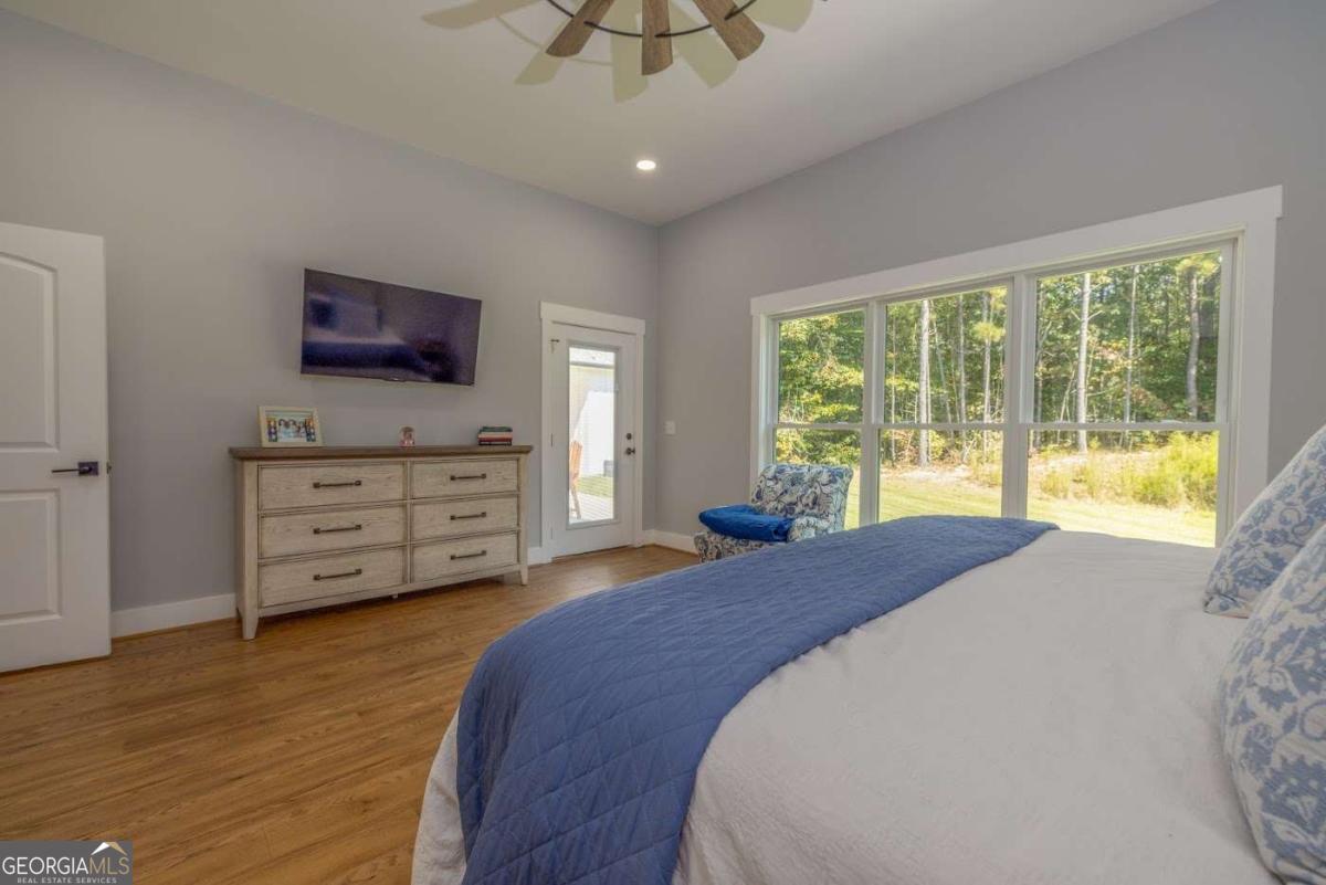 988 Boozer Road Heflin, AL 36264 - Photo 13 of 52 a bed sitting in a spacious bedroom next to a window