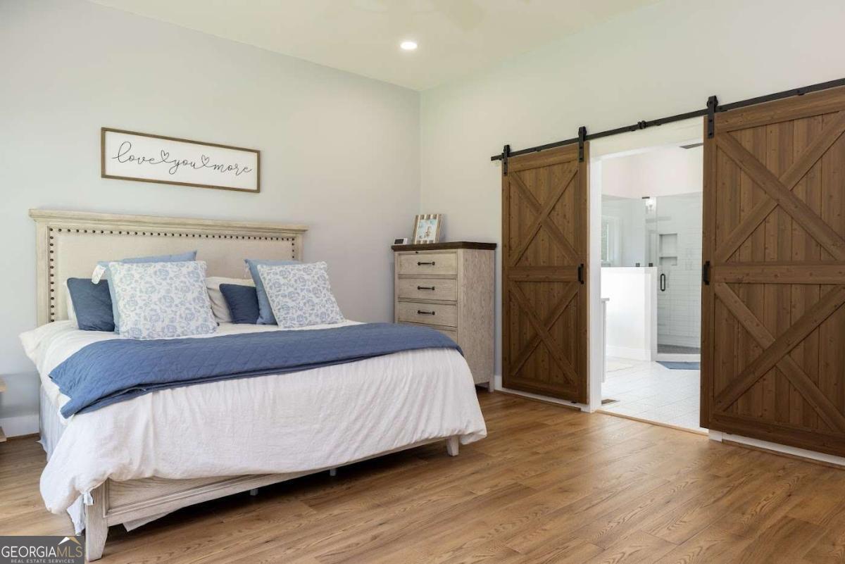 988 Boozer Road Heflin, AL 36264 - Photo 14 of 52 a bedroom with a bed and a refrigerator