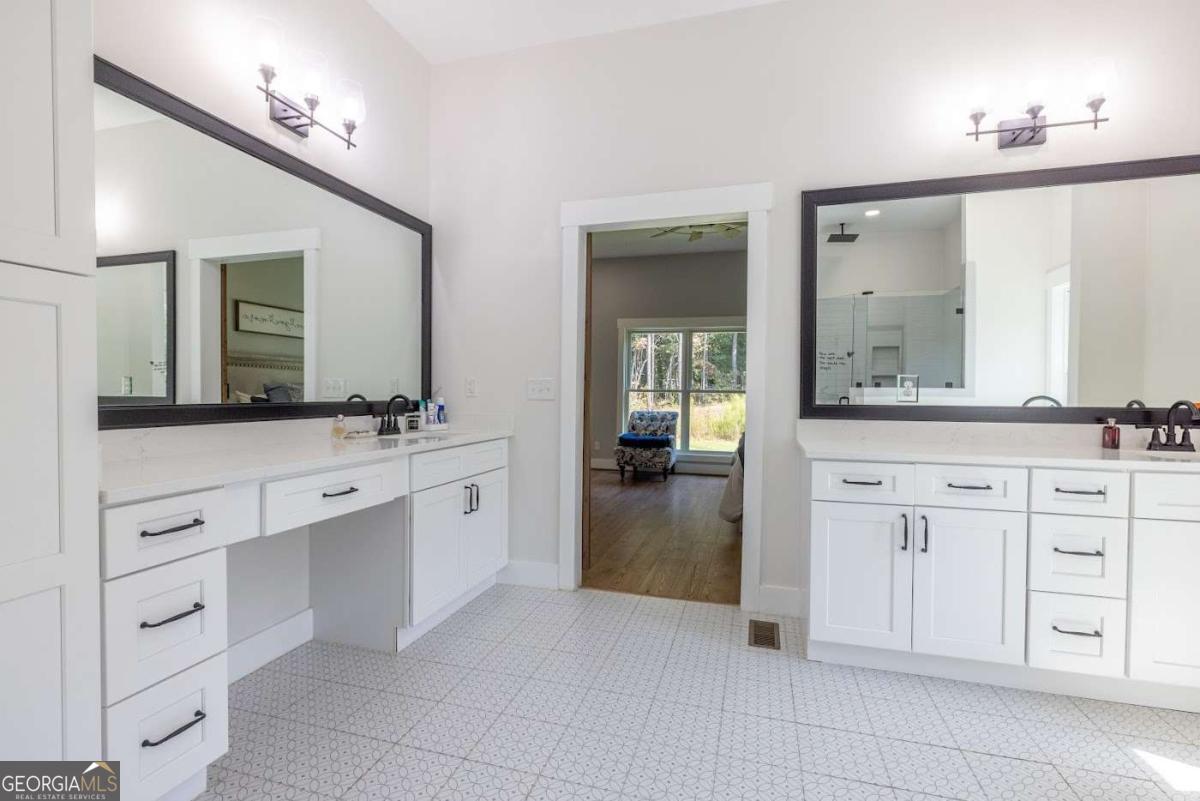 988 Boozer Road Heflin, AL 36264 - Photo 17 of 52 a spacious en suite bathroom with a granite countertop sink and mirror