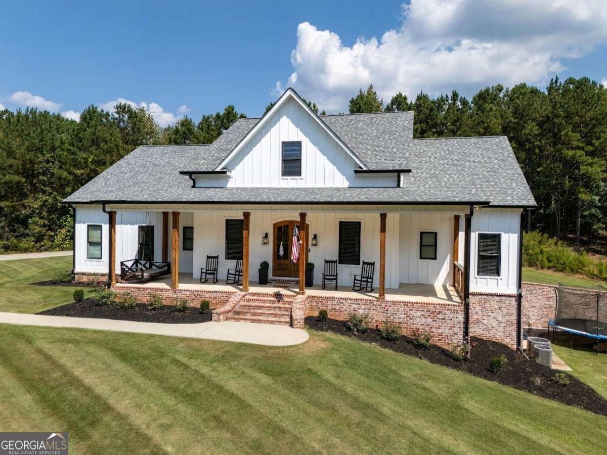 988 Boozer Road Heflin, AL 36264 - Photo 2 of 52 a view of a house with swimming pool and sitting area