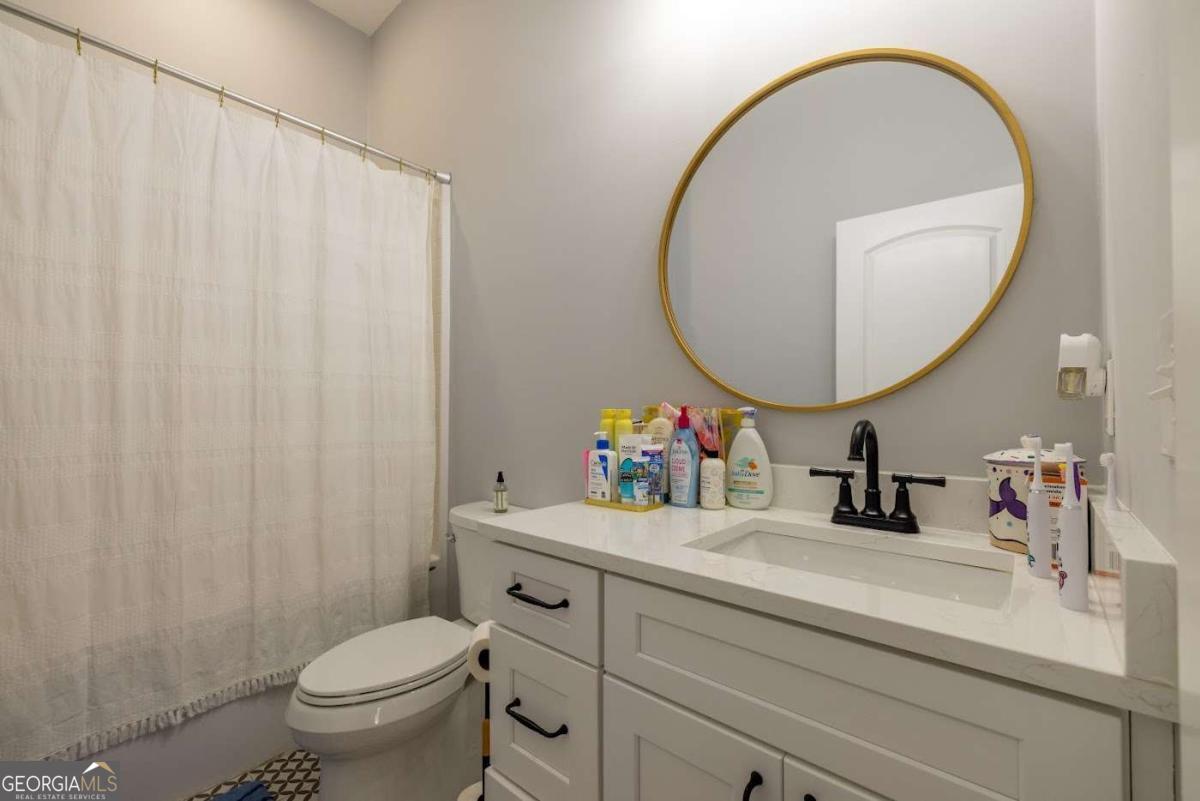988 Boozer Road Heflin, AL 36264 - Photo 21 of 52 a bathroom with a sink mirror and toilet
