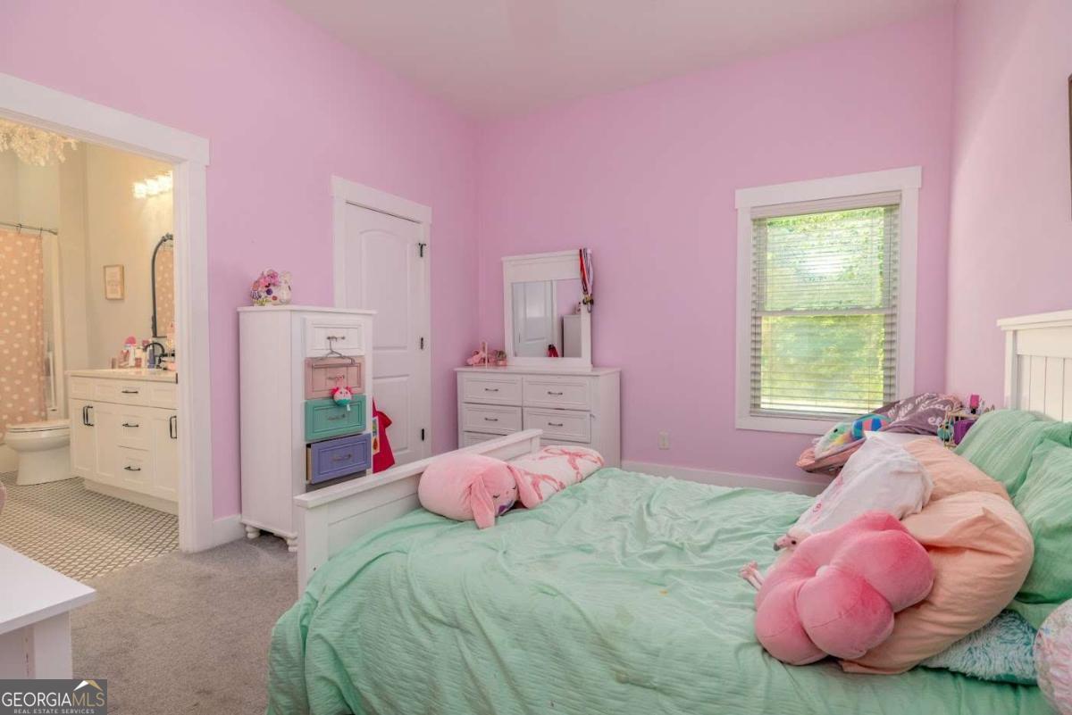 988 Boozer Road Heflin, AL 36264 - Photo 22 of 52 a bedroom with pink bed and a window