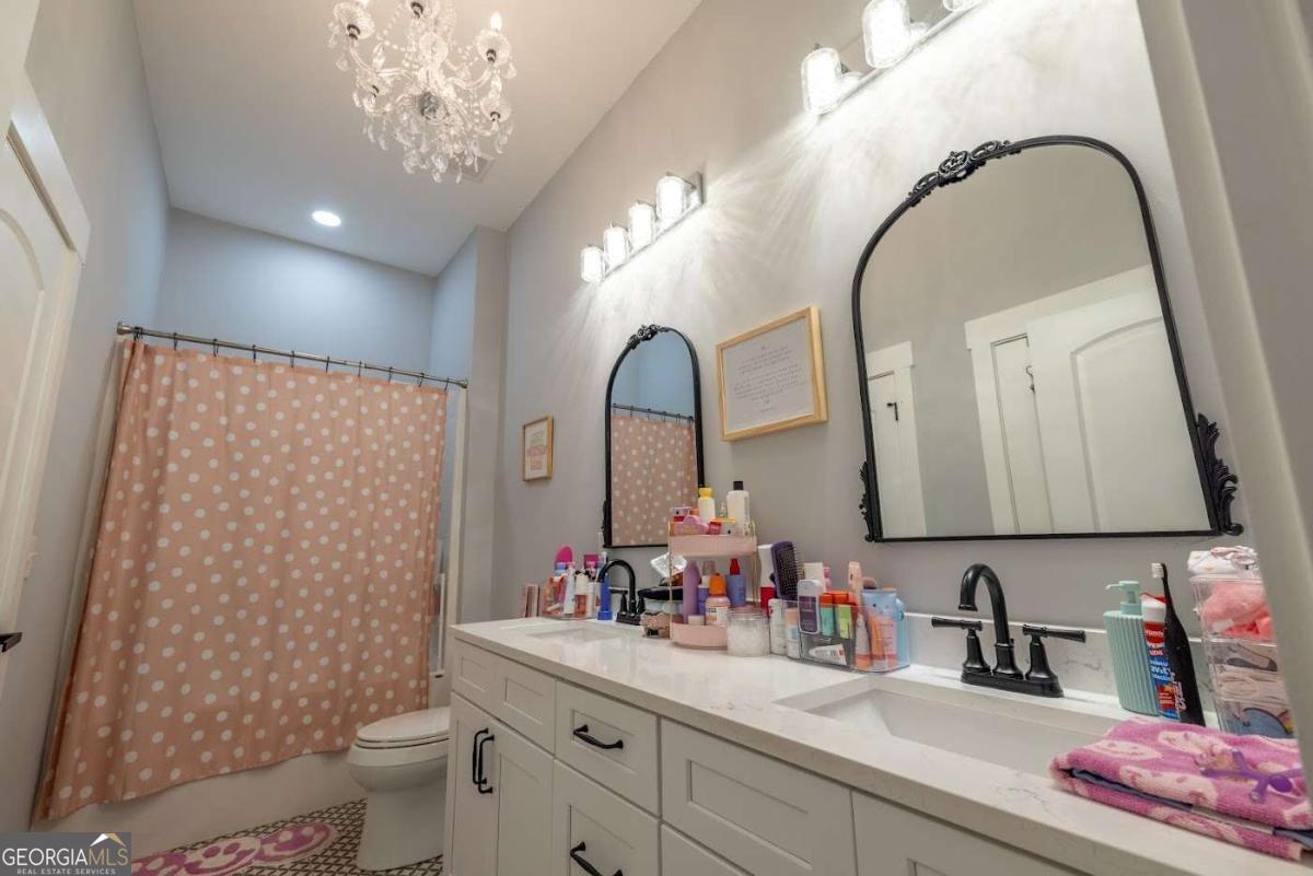 988 Boozer Road Heflin, AL 36264 - Photo 23 of 52 a bathroom with a sink mirror and toilet