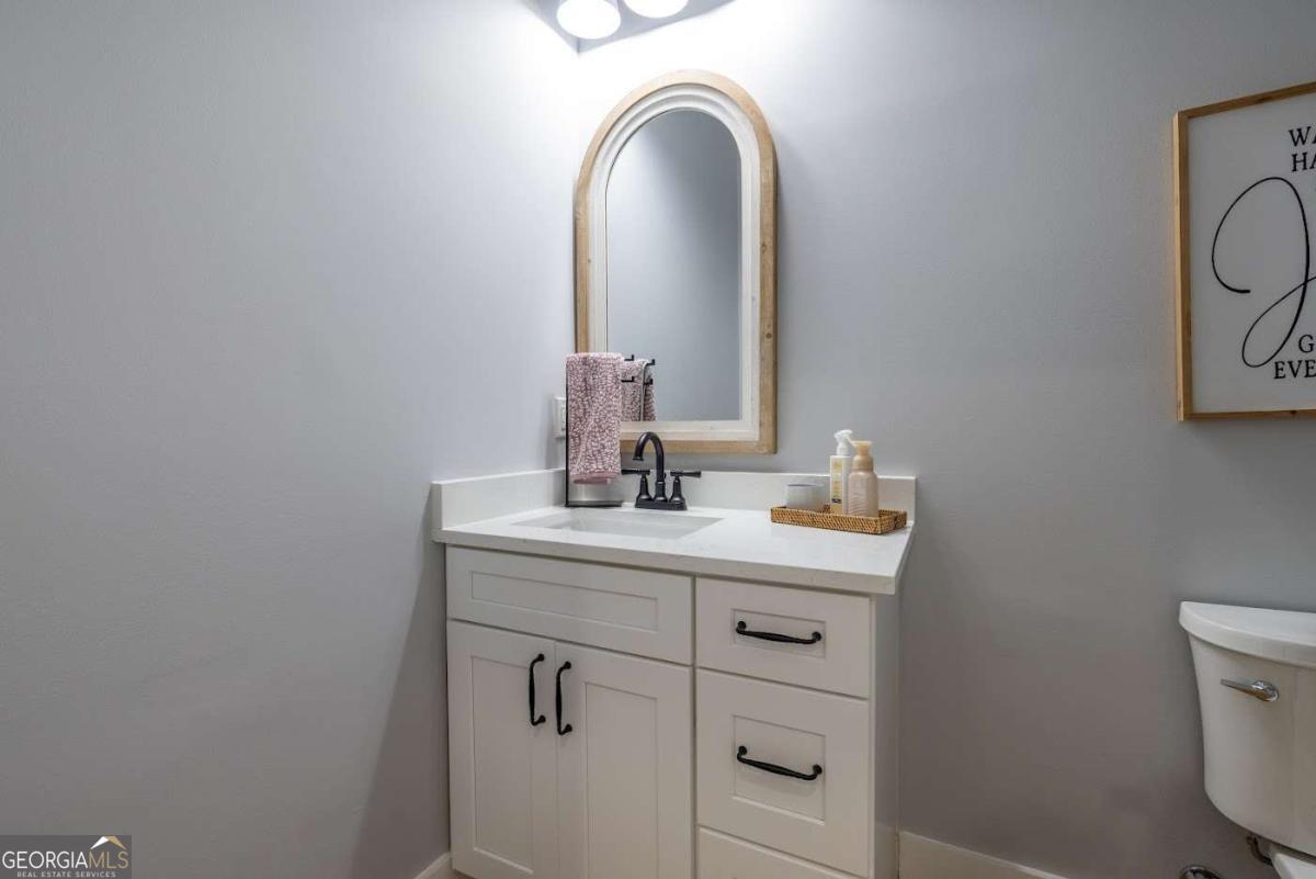 988 Boozer Road Heflin, AL 36264 - Photo 28 of 52 a bathroom with a sink a toilet and a mirror