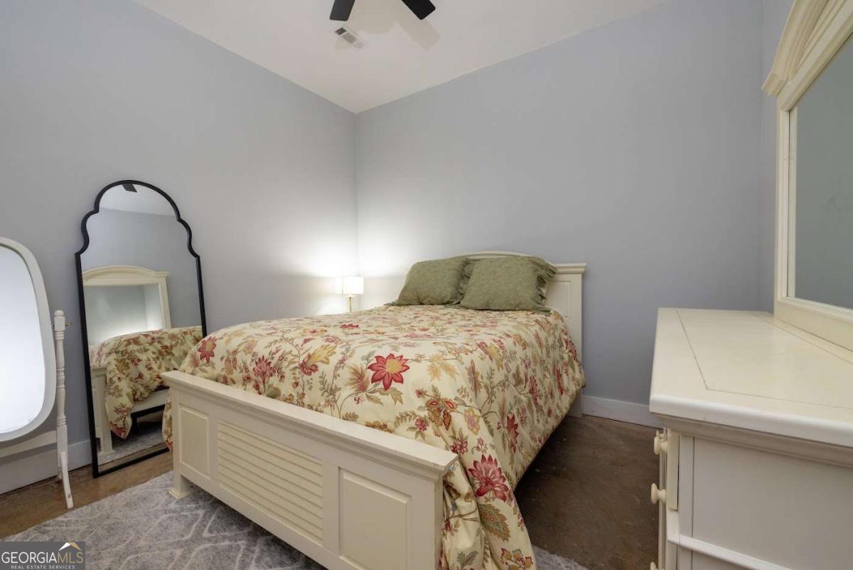 988 Boozer Road Heflin, AL 36264 - Photo 34 of 52 a bedroom with a bed and a mirror