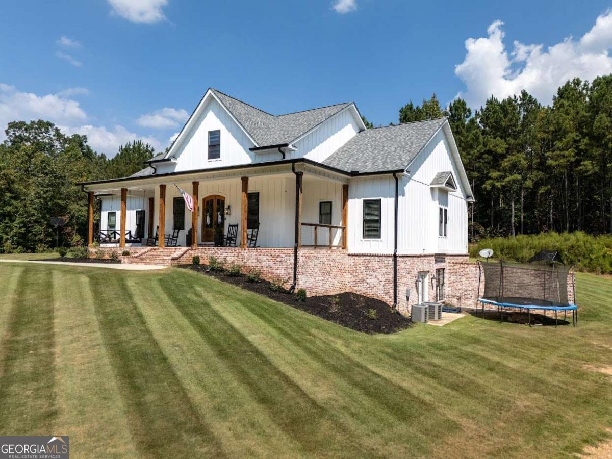 988 Boozer Road Heflin, AL 36264 - Photo 38 of 52 a view of a house with pool and chairs