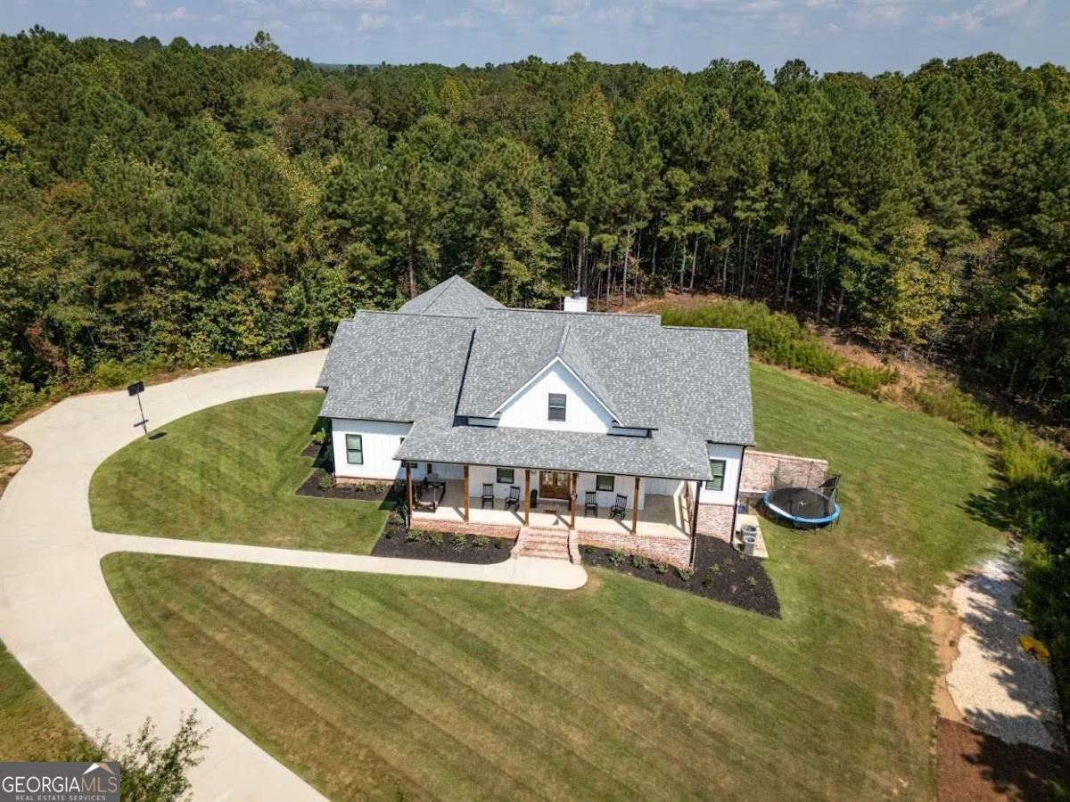 988 Boozer Road Heflin, AL 36264 - Photo 43 of 52 an aerial view of a house with swimming pool and big yard