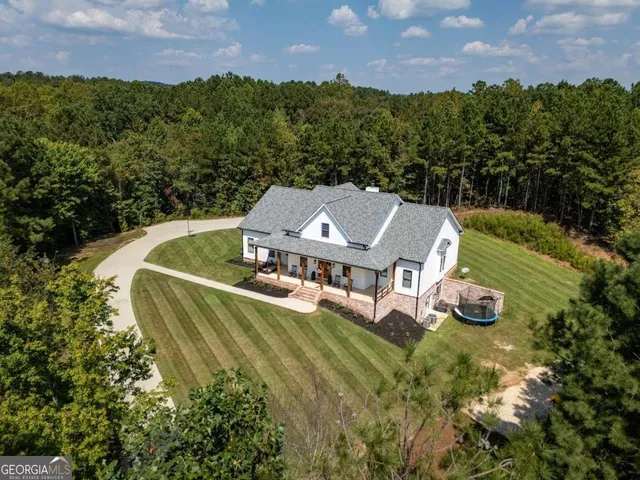 an aerial view of a house with outdoor space