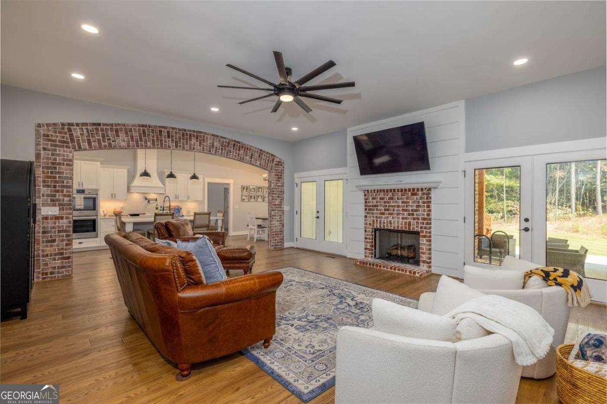 988 Boozer Road Heflin, AL 36264 - Photo 6 of 52 a living room with furniture a fireplace and a flat screen tv