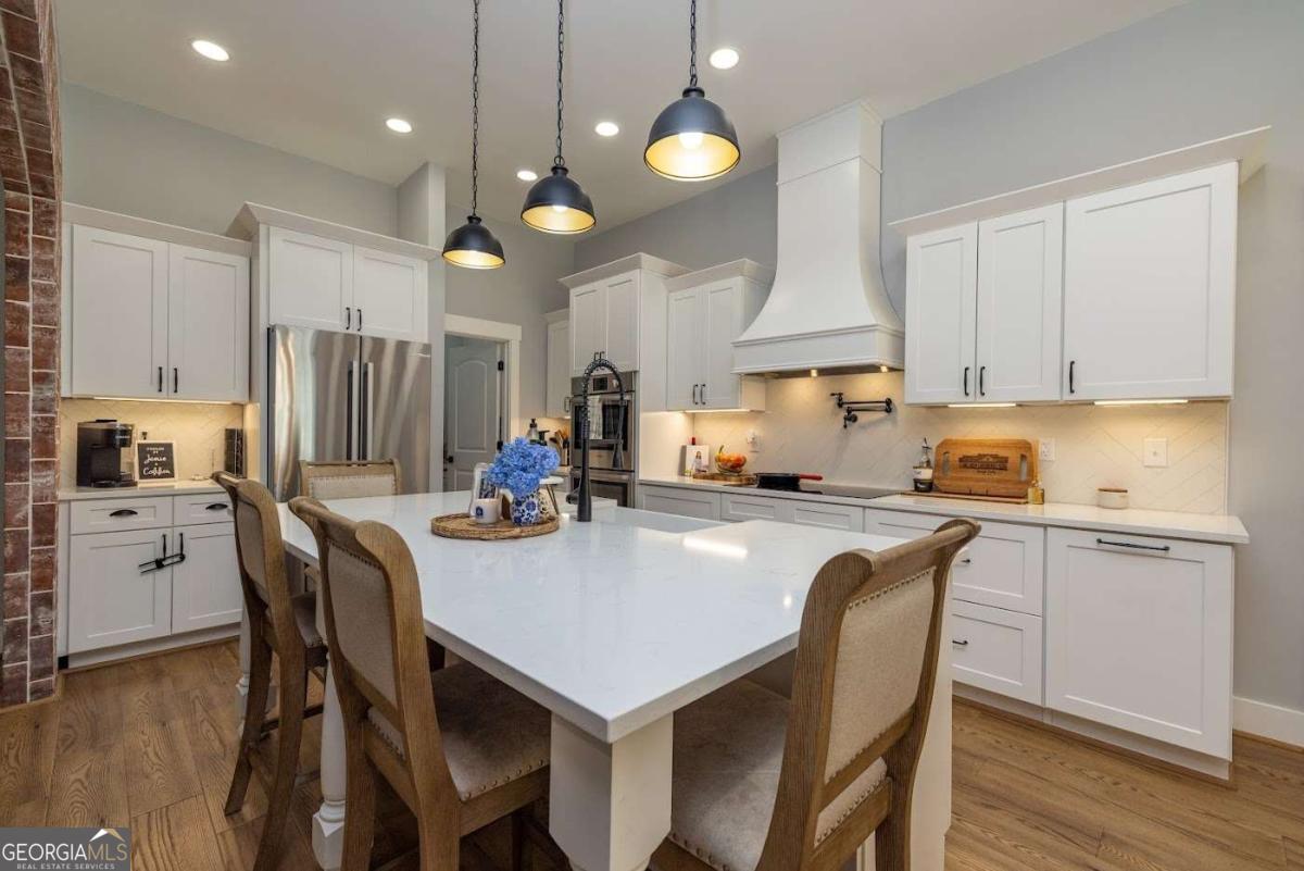 988 Boozer Road Heflin, AL 36264 - Photo 7 of 52 a kitchen with a table chairs sink and cabinets