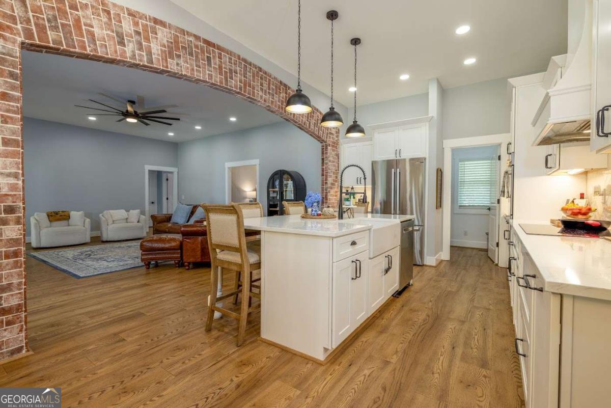 988 Boozer Road Heflin, AL 36264 - Photo 9 of 52 a large white kitchen with lots of counter space a sink and cabinets