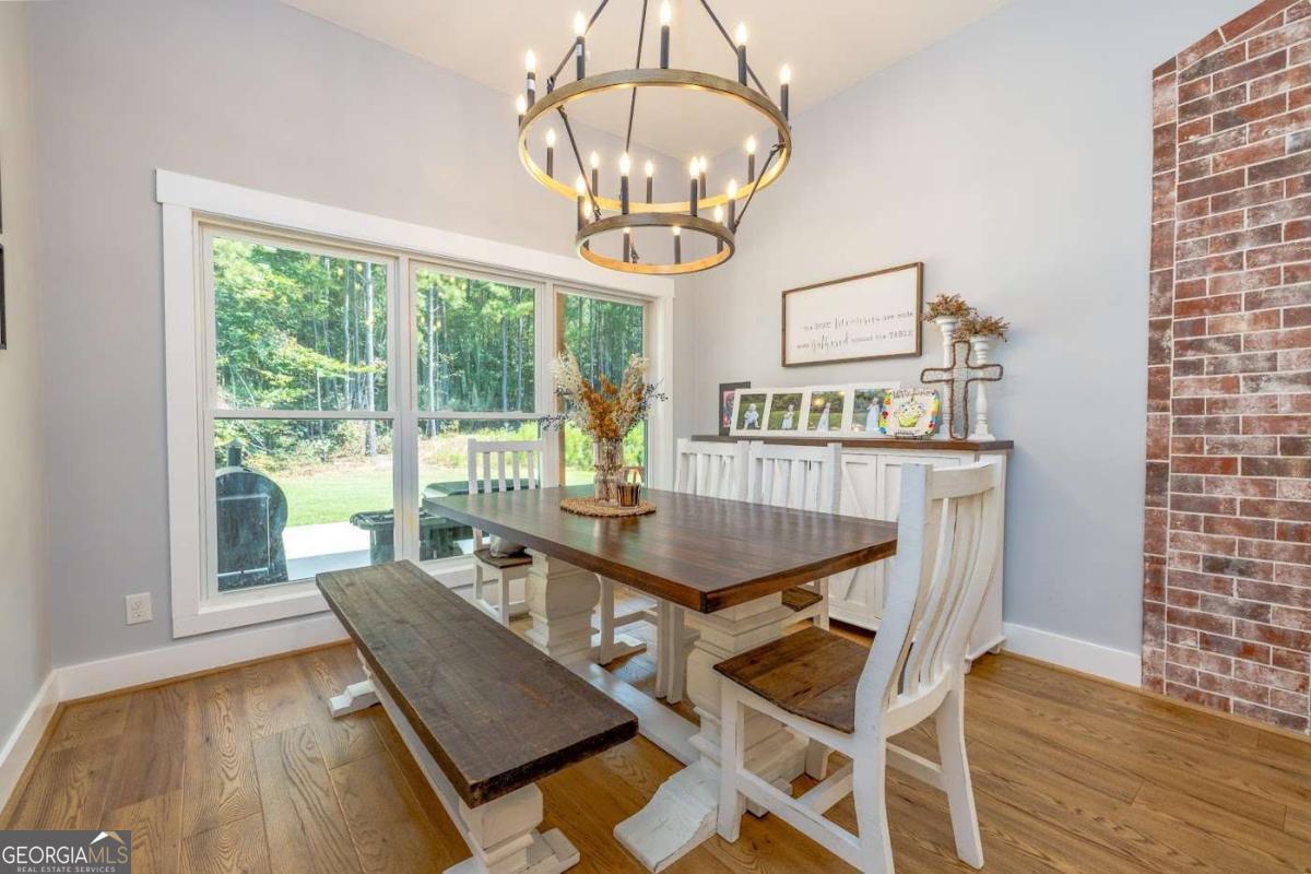 988 Boozer Road Heflin, AL 36264 - Photo 10 of 52 a view of a dining room with furniture wooden floor and chandelier