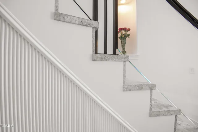 a living room with furniture a flat screen tv and a floor to ceiling window