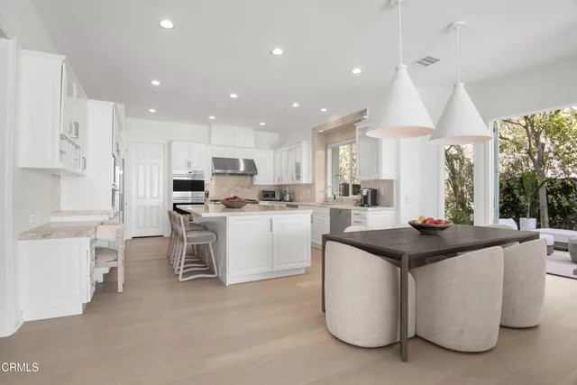 a living room with furniture and a pool table