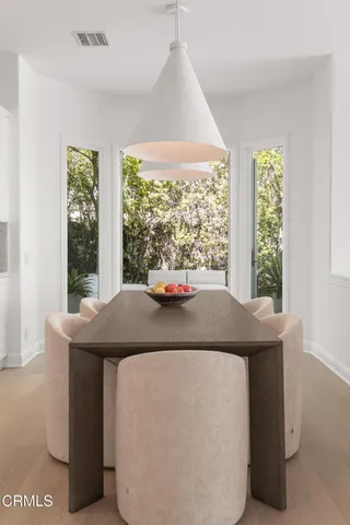 a room with pool table and windows