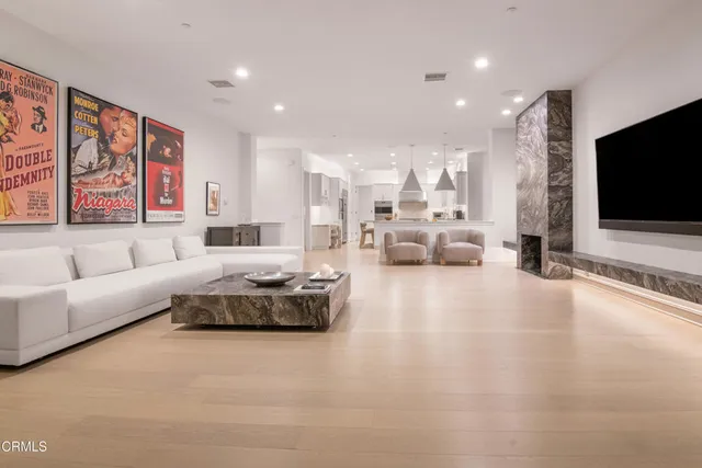 a living room with fireplace furniture and a flat screen tv