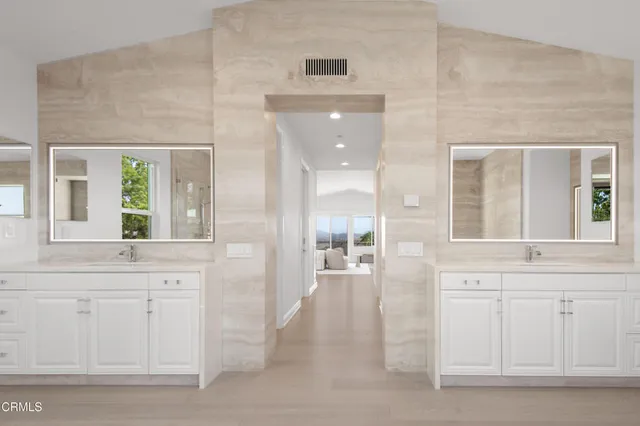 a bedroom with bed and glass window