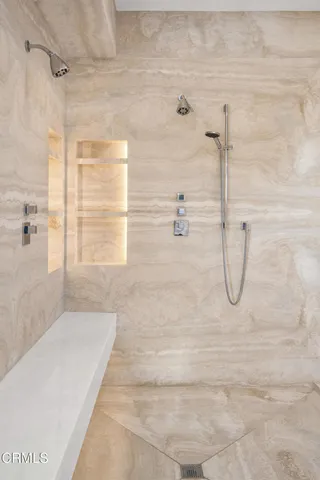 a large bed sitting in a bedroom next to a window