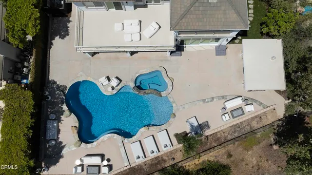 a backyard of a house with table and chairs