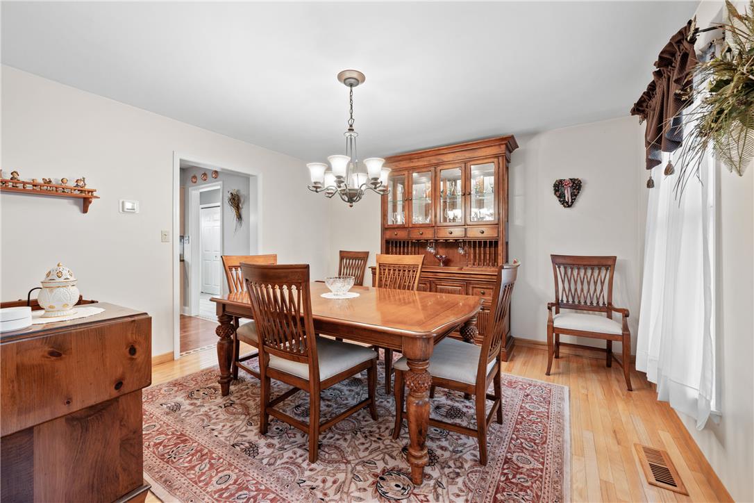 4568 Greenfield Road Bethlehem, PA 18017 - Photo 7 of 59 A classic dining area with rich wooden floors and an inviting chandelier.