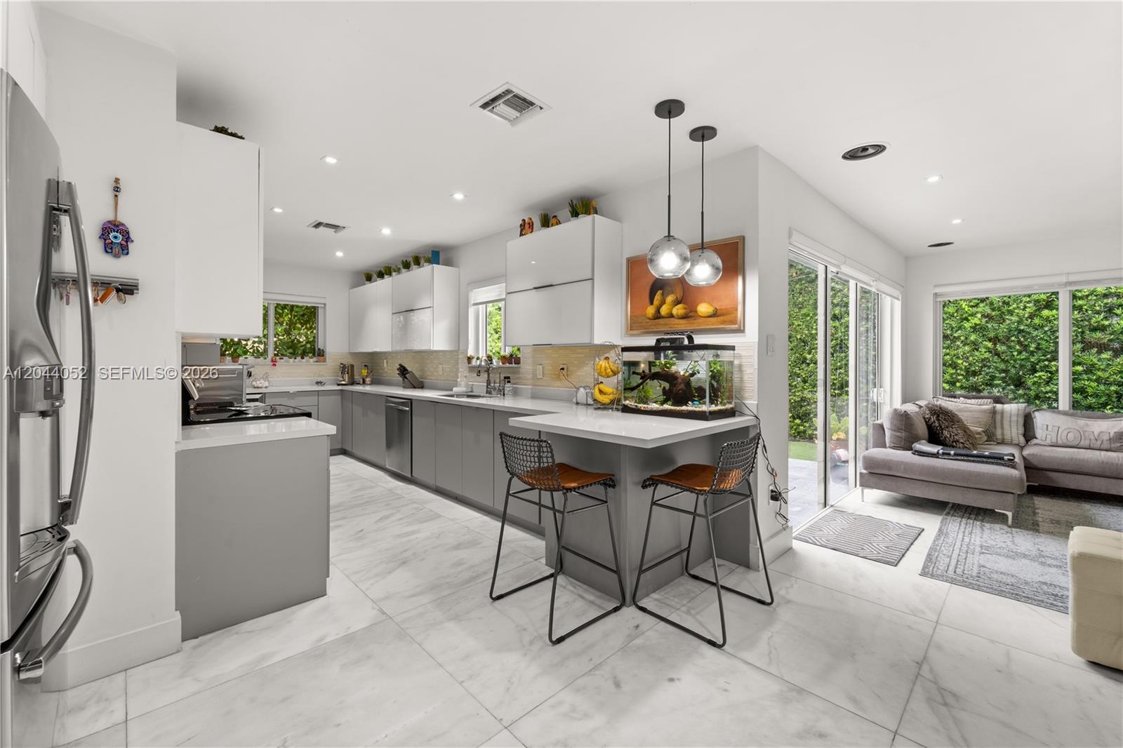 721 Bird Road Coral Gables, FL 33146 - Photo 7 of 24 a living room with stainless steel appliances kitchen island granite countertop furniture and a view of kitchen