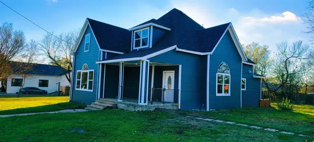 a view of a house with a swimming pool and a yard