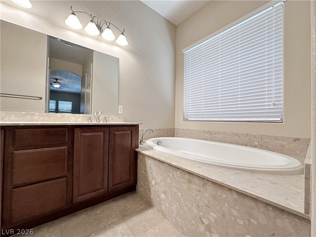 71 Newton Ridge Way Las Vegas, NV 89183 - Photo 30 of 40 Indulge in relaxation with this inviting soaking tub, complemented by a spacious vanity.