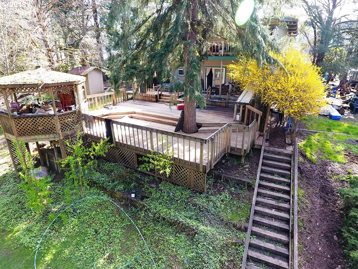21953 South Redland Road Estacada, OR 97023 - Photo 6 of 25 a view of a patio with table and chairs potted plants and a large tree