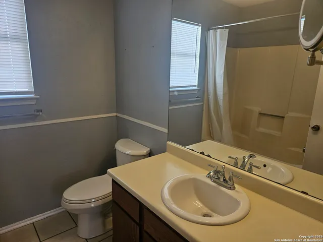 a bathroom with a sink toilet and mirror