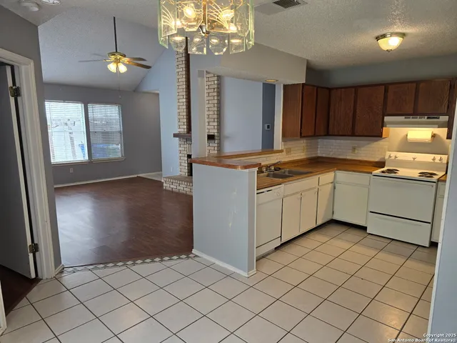 a kitchen with stainless steel appliances granite countertop a sink and a stove