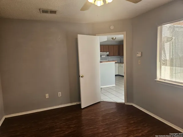 an empty room with wooden floor and a window