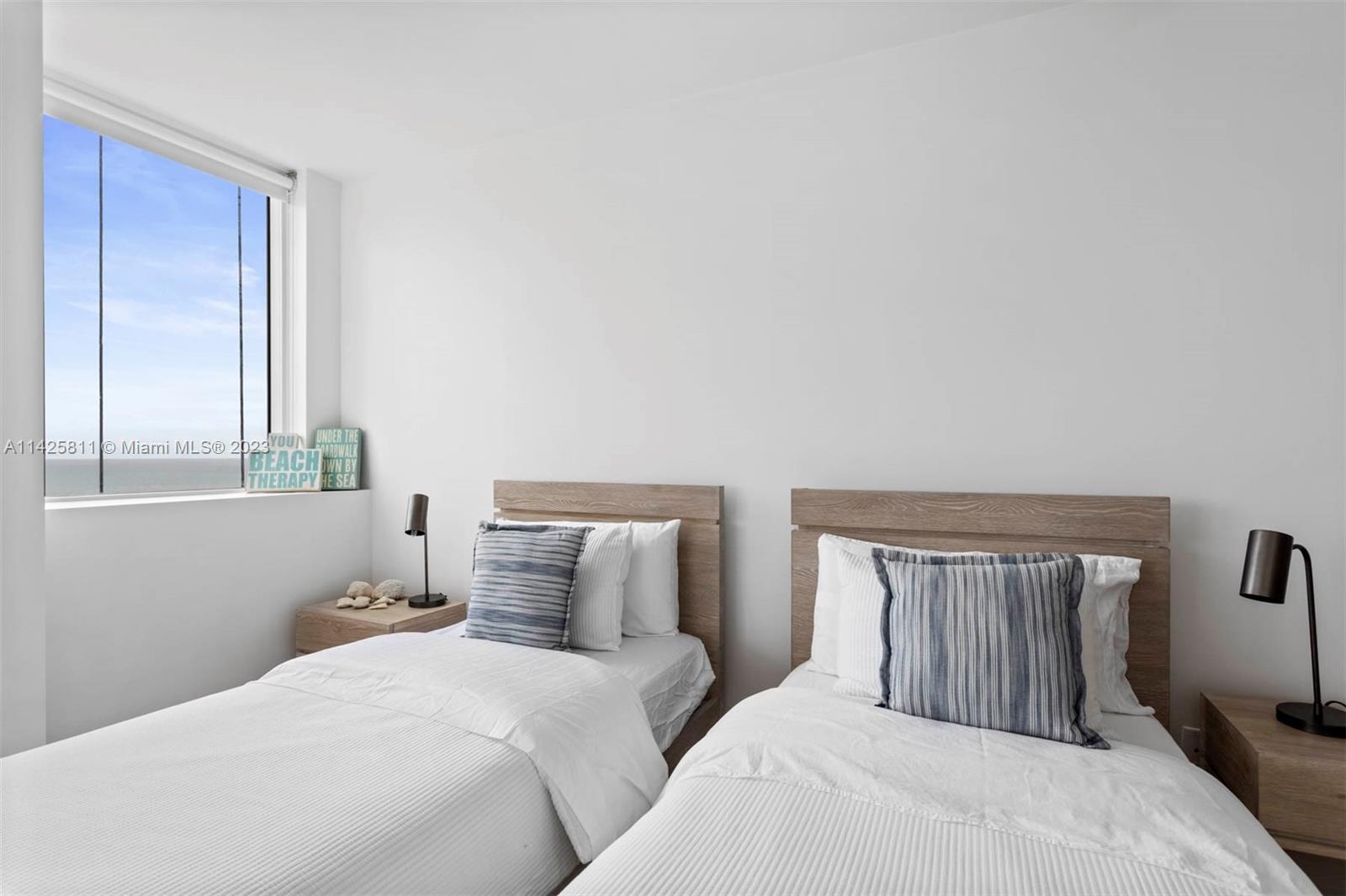 4779 Collins Avenue, Unit 1908 Miami Beach, FL 33140 - Photo 16 of 36 a bedroom with a bed and a window