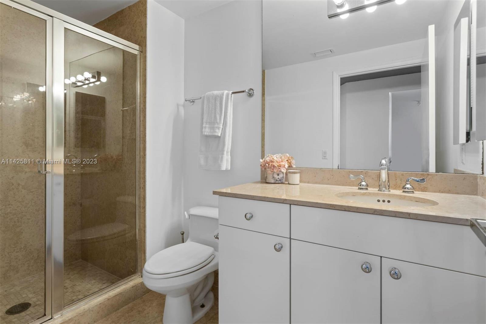 4779 Collins Avenue, Unit 1908 Miami Beach, FL 33140 - Photo 18 of 36 a bathroom with a sink toilet and shower