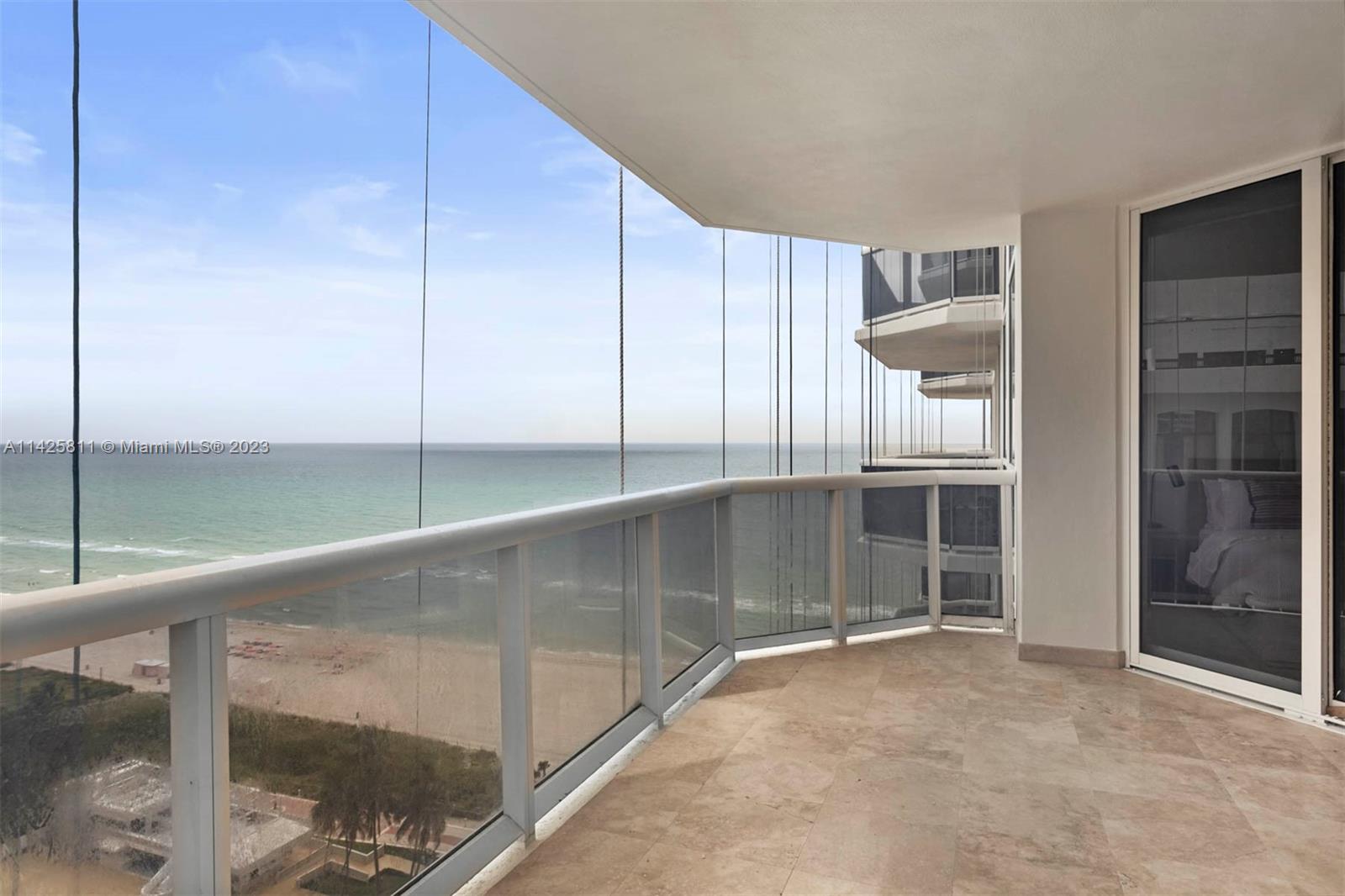 4779 Collins Avenue, Unit 1908 Miami Beach, FL 33140 - Photo 19 of 36 a view of an empty room with a glass door