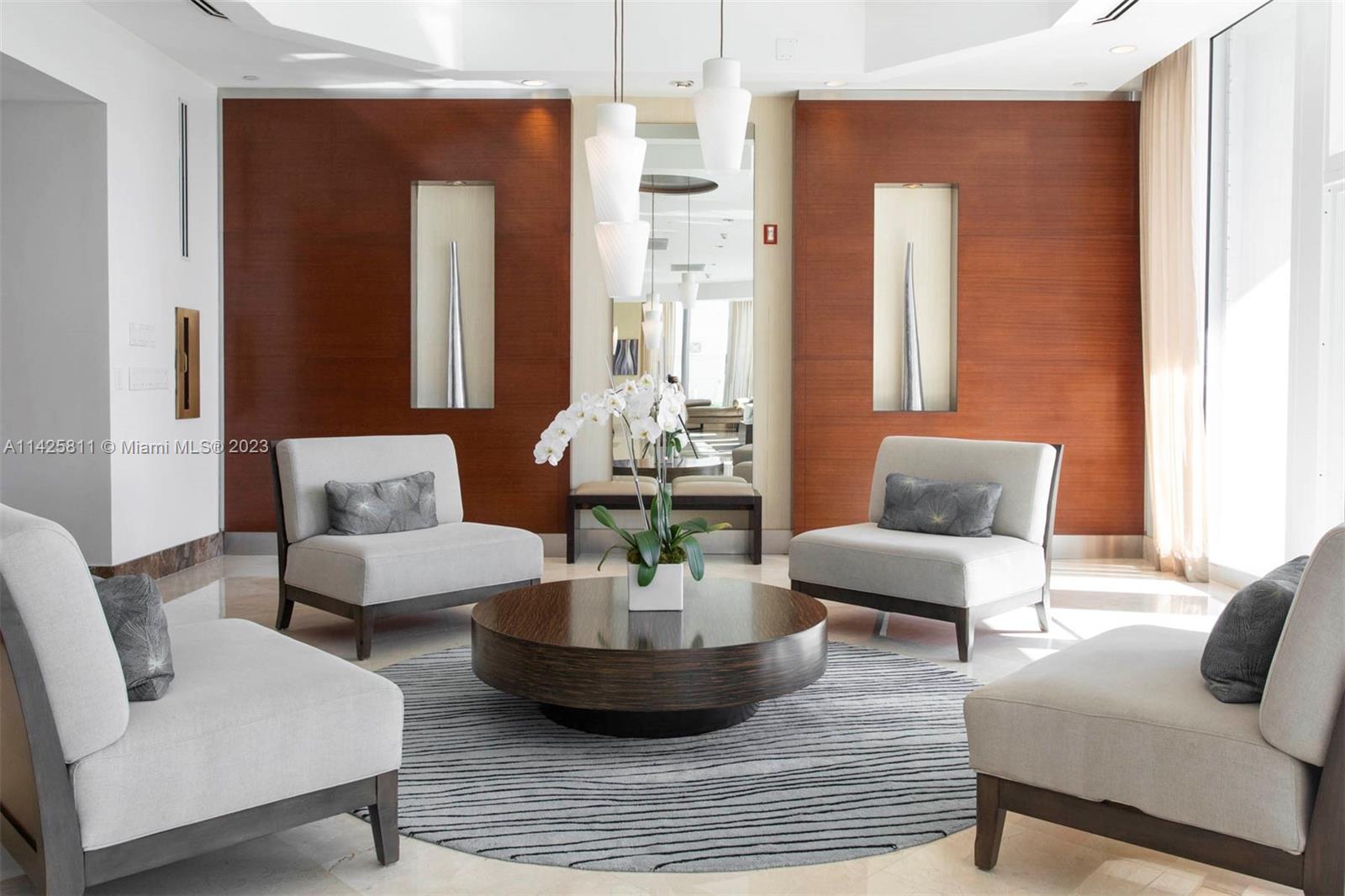 4779 Collins Avenue, Unit 1908 Miami Beach, FL 33140 - Photo 32 of 36 a living room with furniture and a potted plant