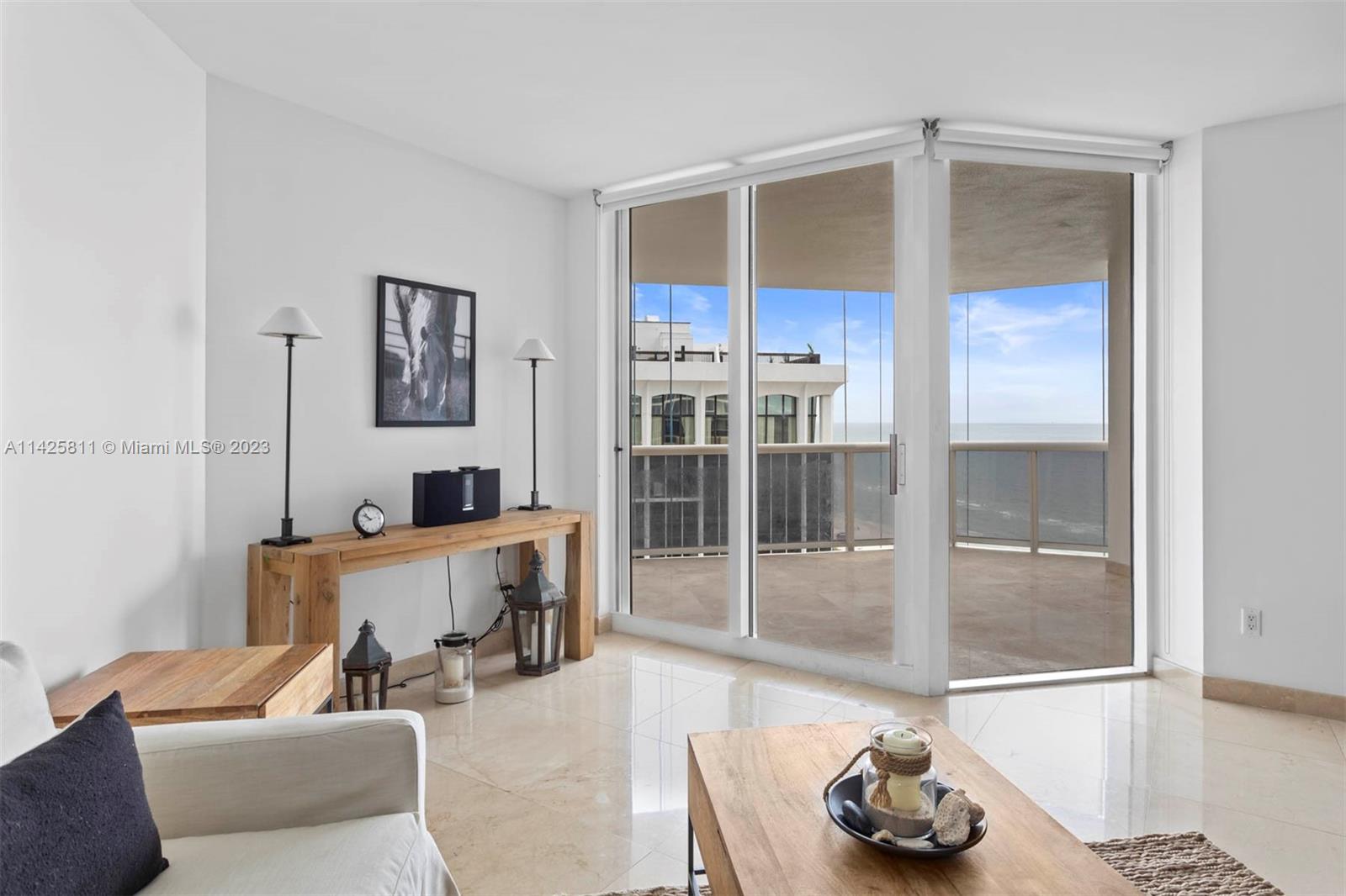 4779 Collins Avenue, Unit 1908 Miami Beach, FL 33140 - Photo 4 of 36 a living room with furniture and a wooden floor