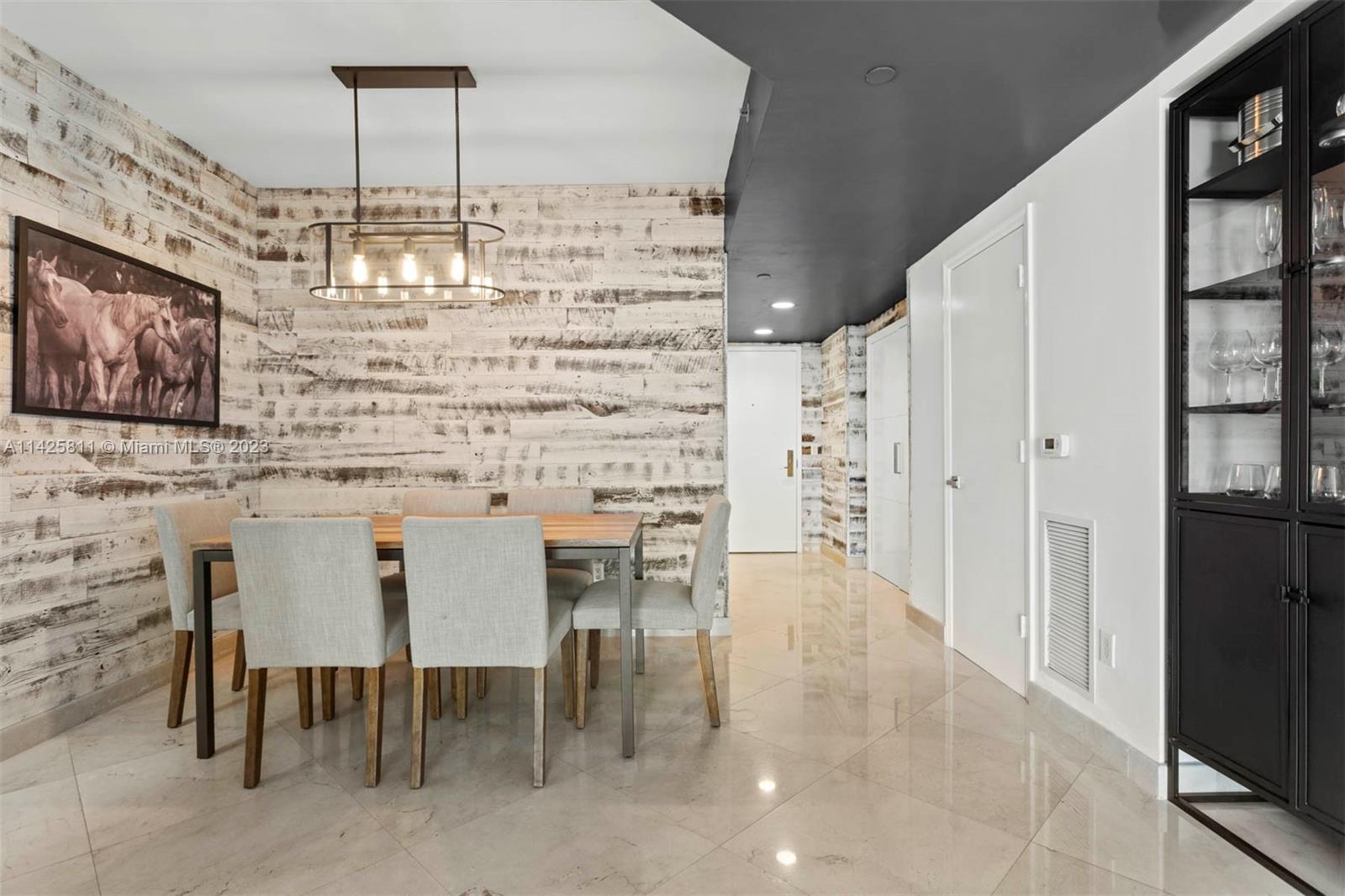 4779 Collins Avenue, Unit 1908 Miami Beach, FL 33140 - Photo 6 of 36 a dining room with furniture and chandelier