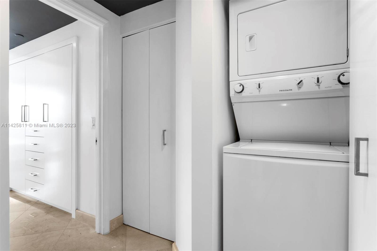 4779 Collins Avenue, Unit 1908 Miami Beach, FL 33140 - Photo 10 of 36 a utility room with dryer and washer