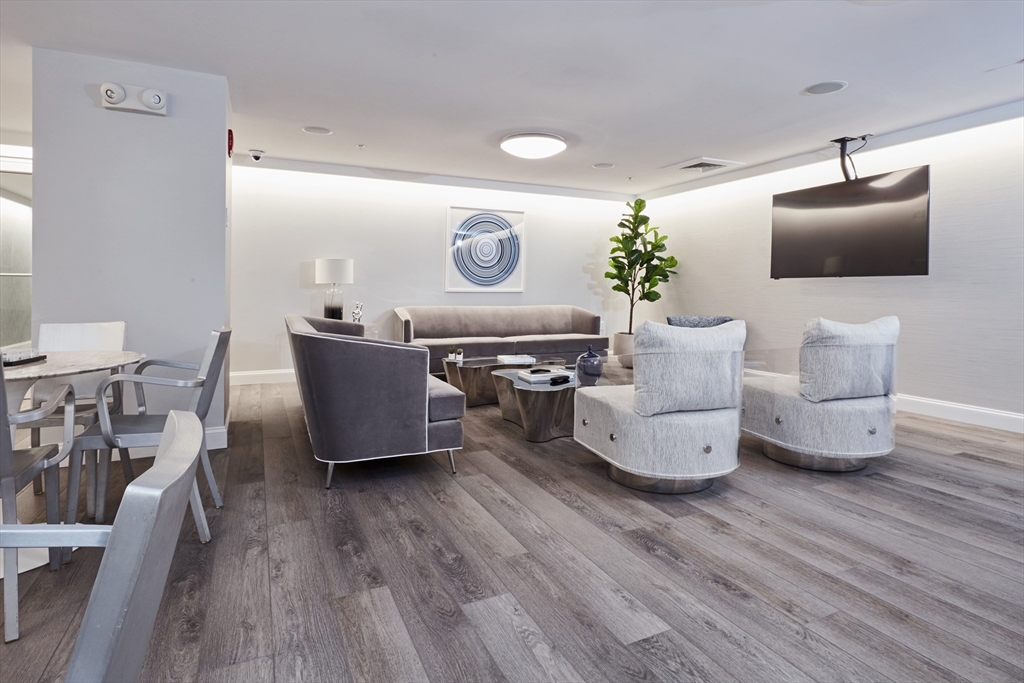 42 8th Street, Unit 5316 Boston, MA 02129 - Photo 10 of 12 a living room with furniture and a flat screen tv