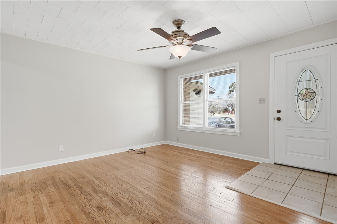 804 Edwards Street Sinton, TX 78387 - Photo 5 of 25 wooden floor in an empty room with a window