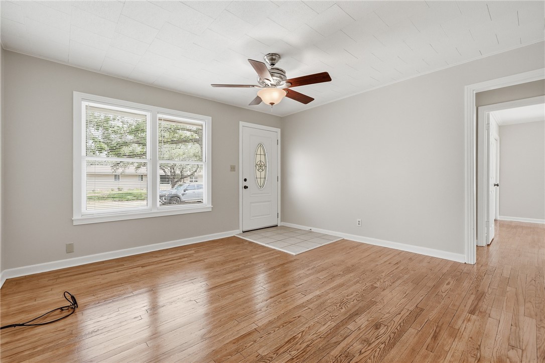 804 Edwards Street Sinton, TX 78387 - Photo 6 of 25 wooden floor in an empty room with a window
